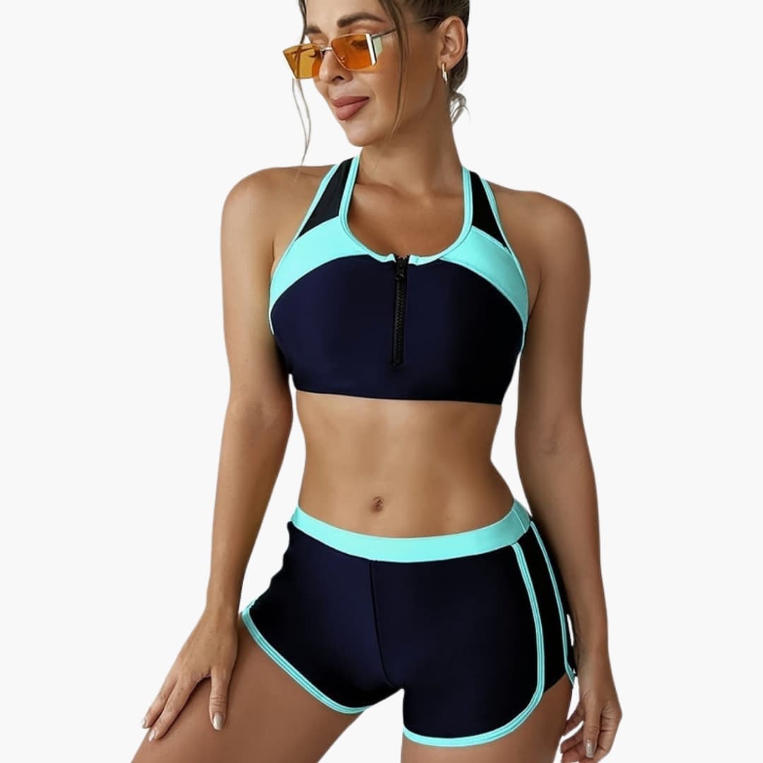 Women's two-piece navy bikini set with aqua trim, zip-front top and side-split bottoms