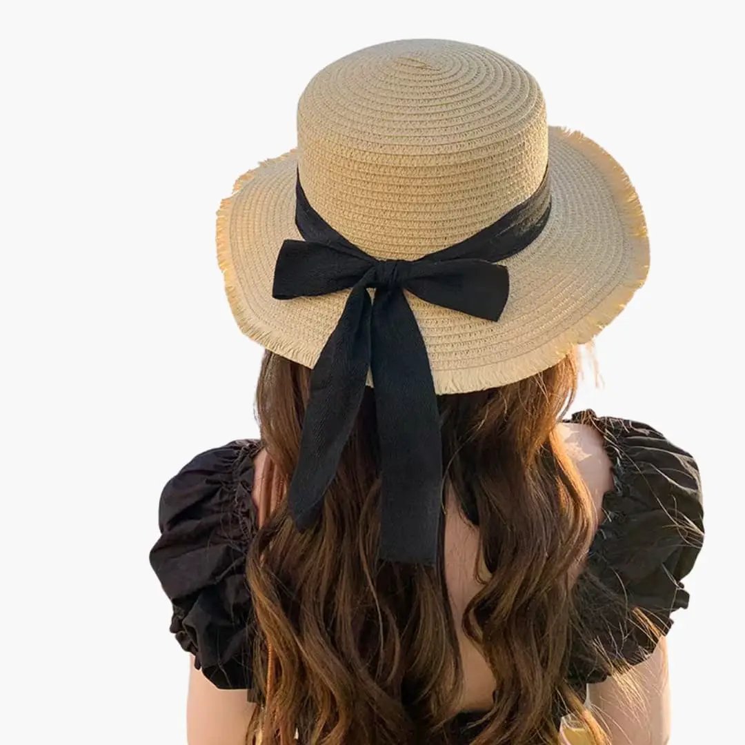 Women's sun hat with wide natural straw brim and black ribbon bow.