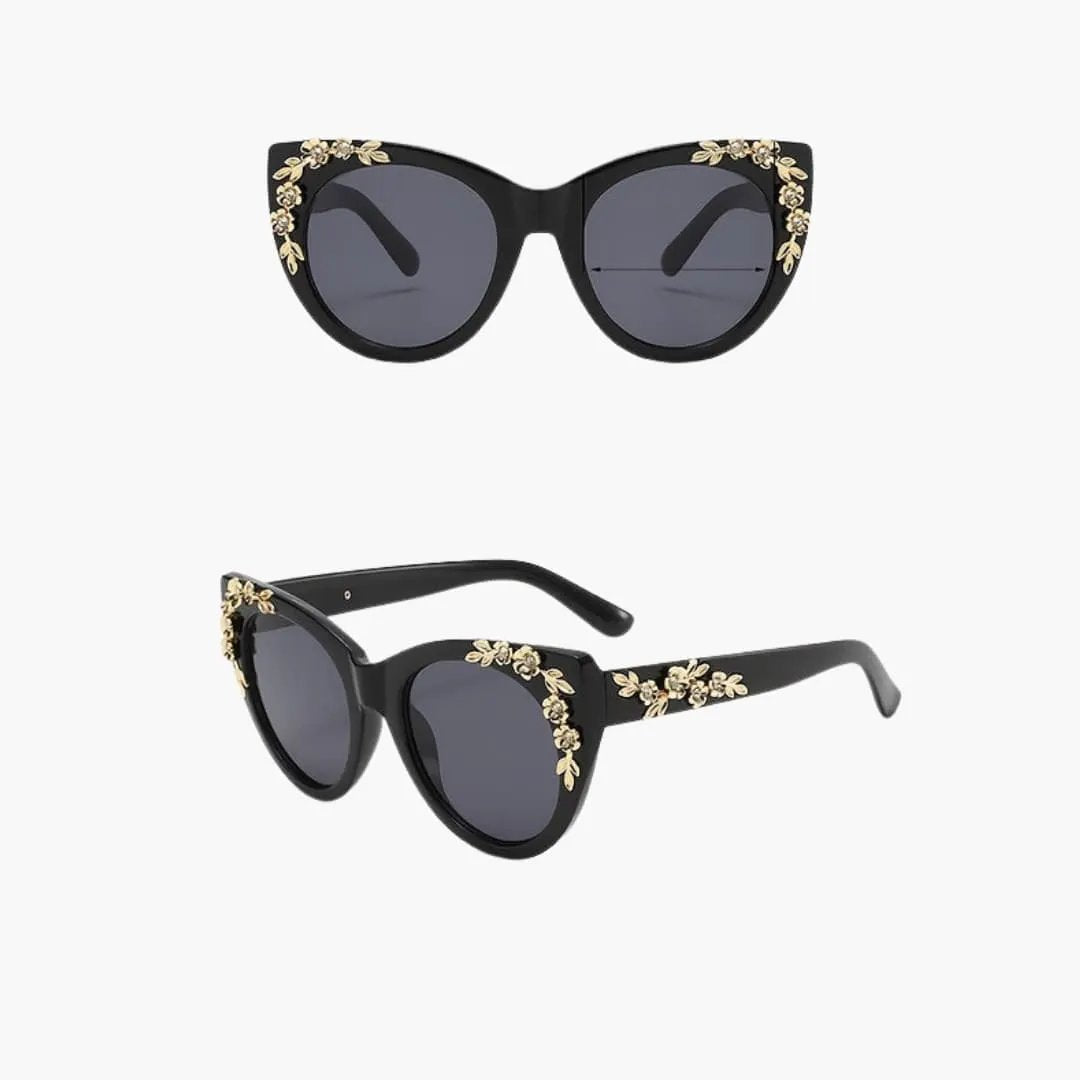 Women's cat-eye sunglasses by Wilfred Smith with black frame, gold floral accents and UV400 polycarbonate lenses