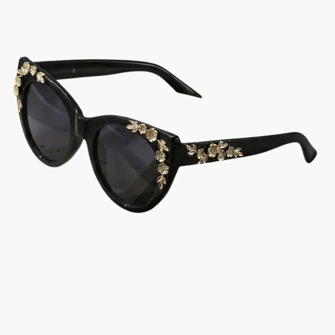 Women's sunglasses by Wilfred Smith, black cat-eye frame with gold floral accents, UV400 polycarbonate lenses.