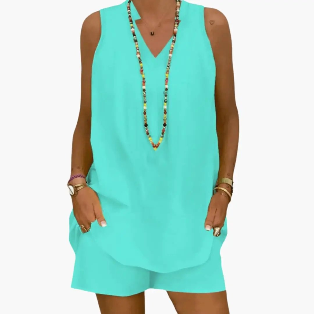 Women’s two-piece tunic and pants set in turquoise featuring a sleeveless longline tunic top