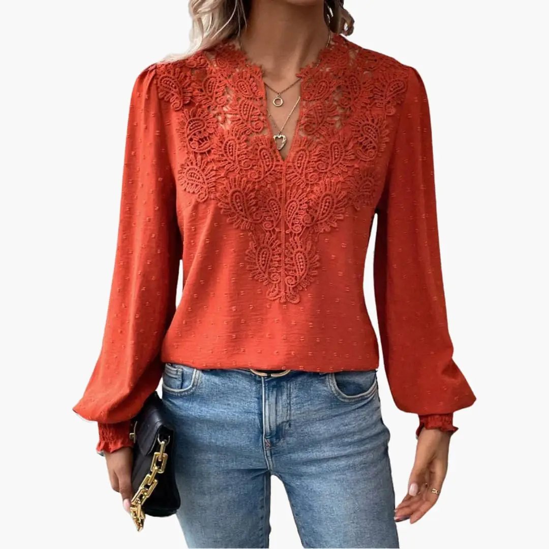 Women's rust-red loose-fit long-sleeve V-neck blouse with lace front panel and smocked cuffs.