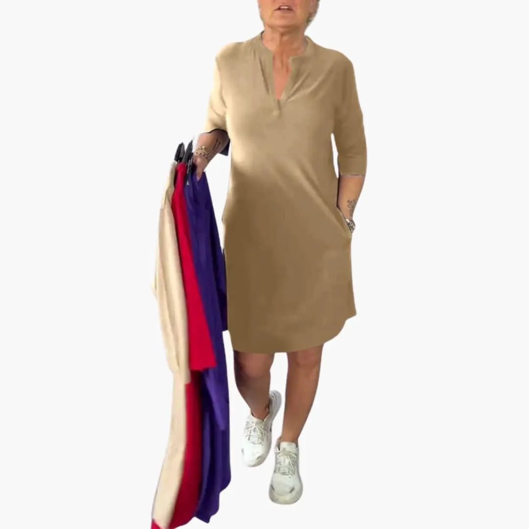Women's V-neck loose-fit midi dress in tan, knee-length, worn by model.