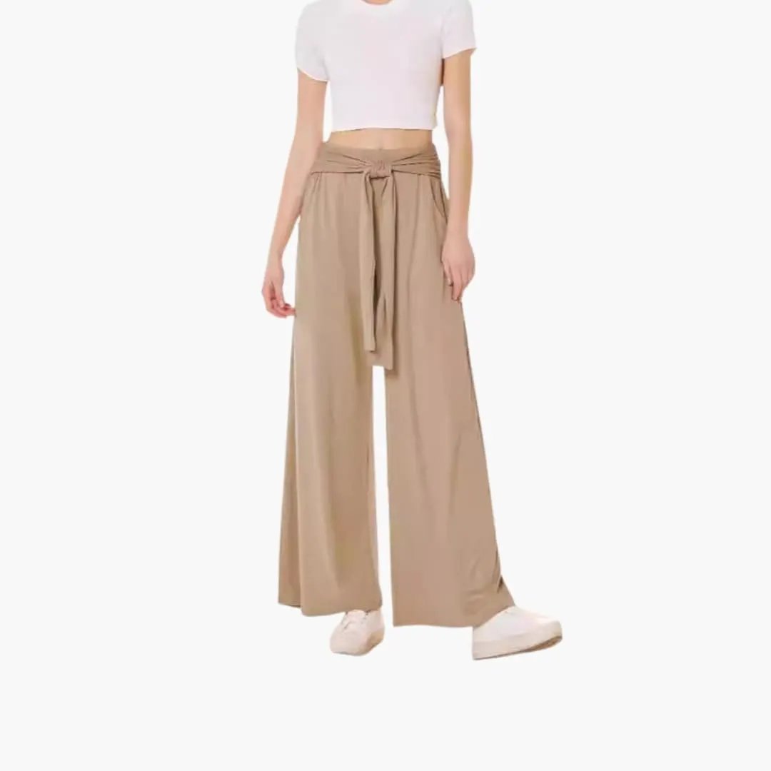 Women's wide-leg trousers in tan with tie belt and side pockets.