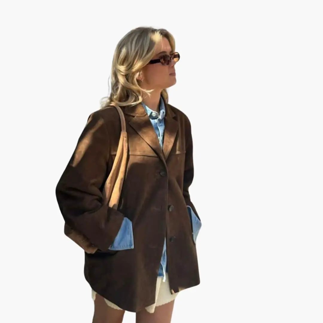 Women's brown suede jacket with front button placket, worn over a light blue denim shirt