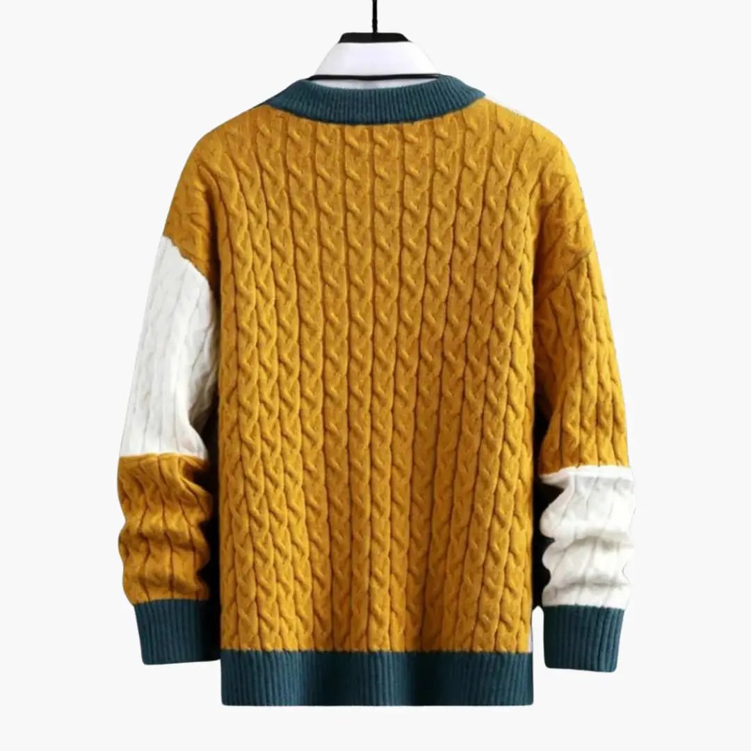 Men's Wilfred Smith cable-knit round-neck sweater in mustard yellow with teal ribbed cuffs and hem and white sleeves.
