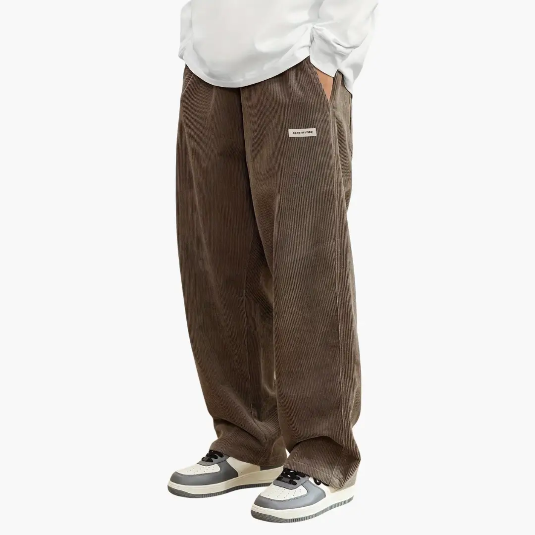 Men's corduroy pants in brown with elastic waistband and pockets by Wilfred Smith