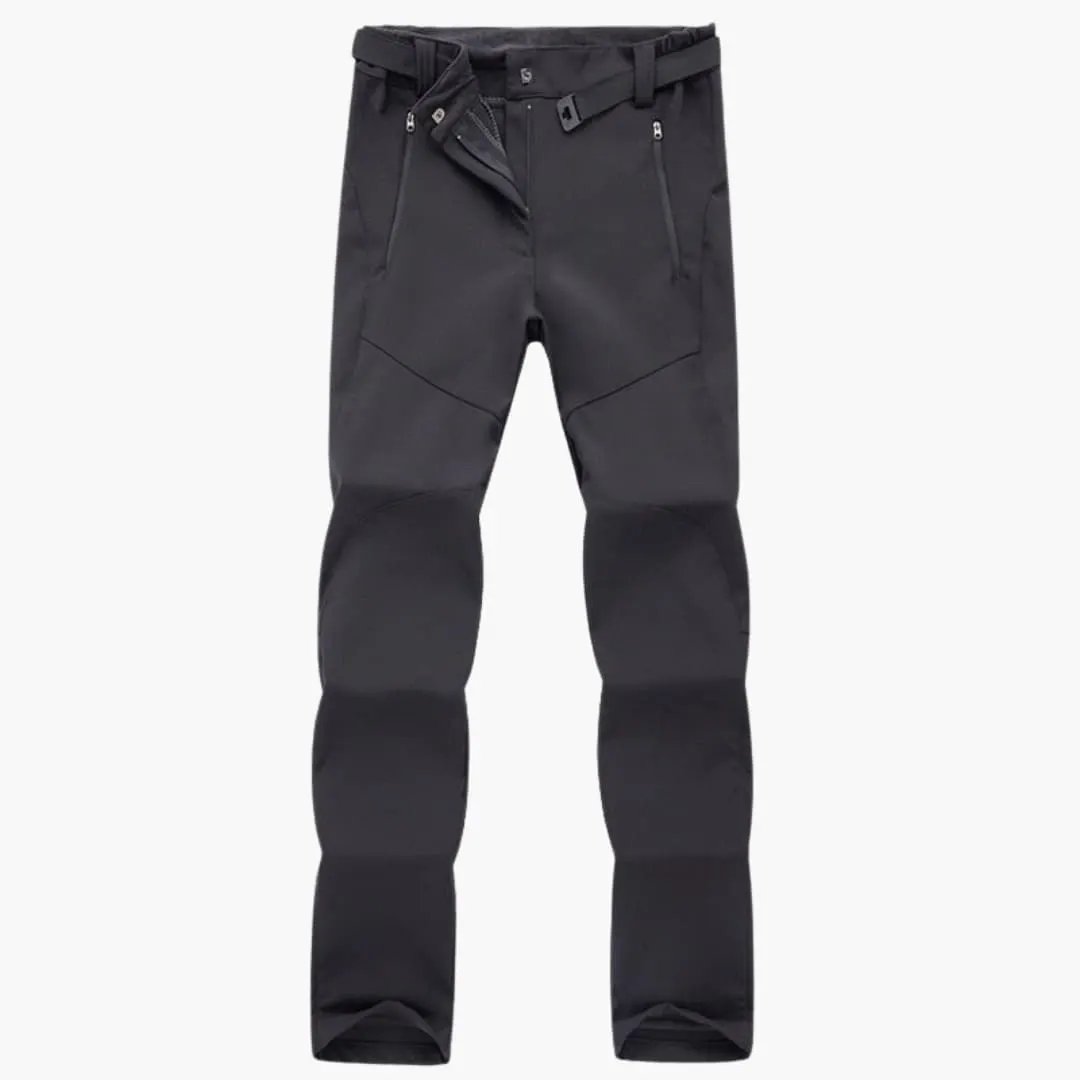 Women's hiking pants with zip pockets by Wilfred Smith, dark gray with knee panels.