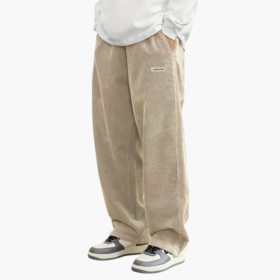 Men's corduroy pants, beige wide-leg with elastic waistband and pockets.
