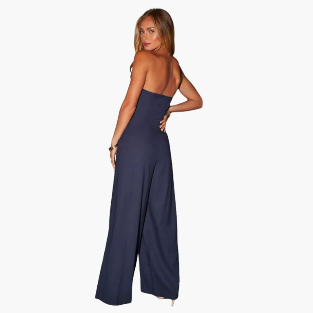 Jumpsuit by Wilfred Smith, navy blue strapless design with wide-leg pants, back view.