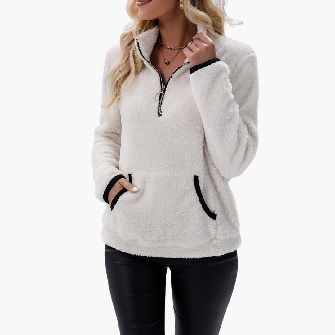 Women's fleece half-zip pullover in white with black-trim pockets by Wilfred Smith.