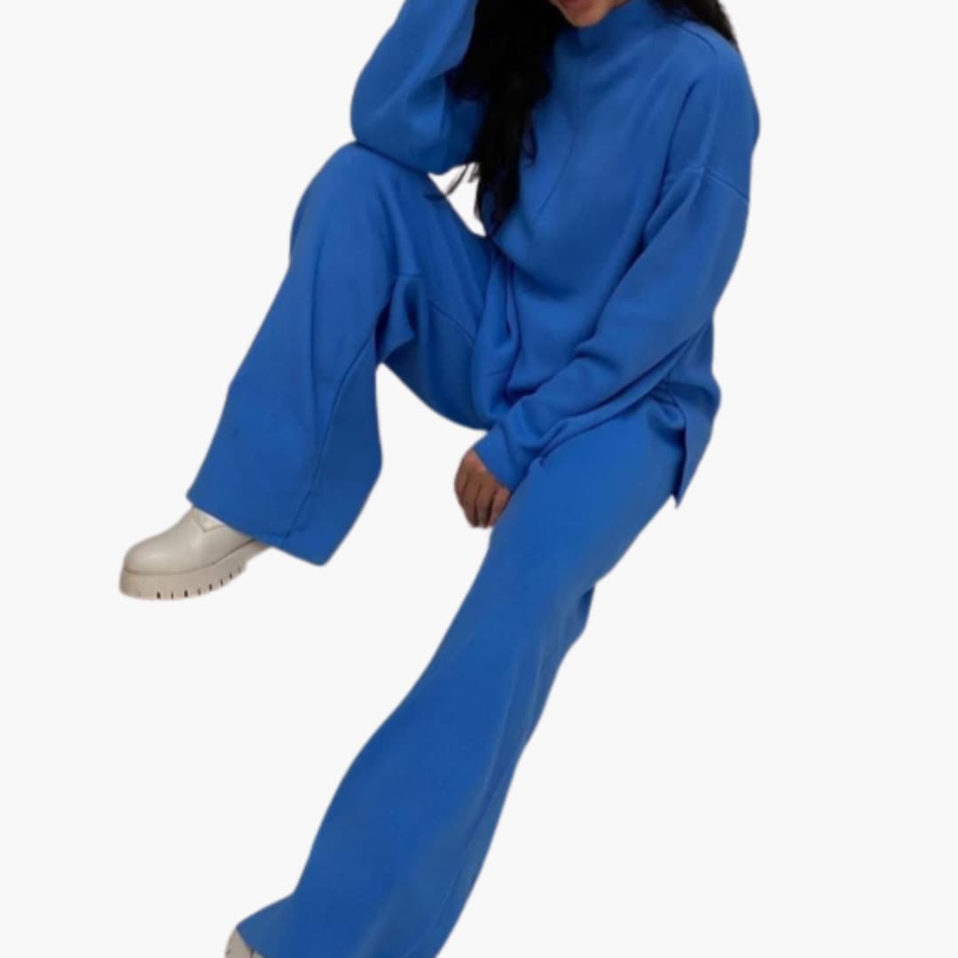 Women's blue loungewear set with sweater and wide-leg pants, model wearing white sneakers