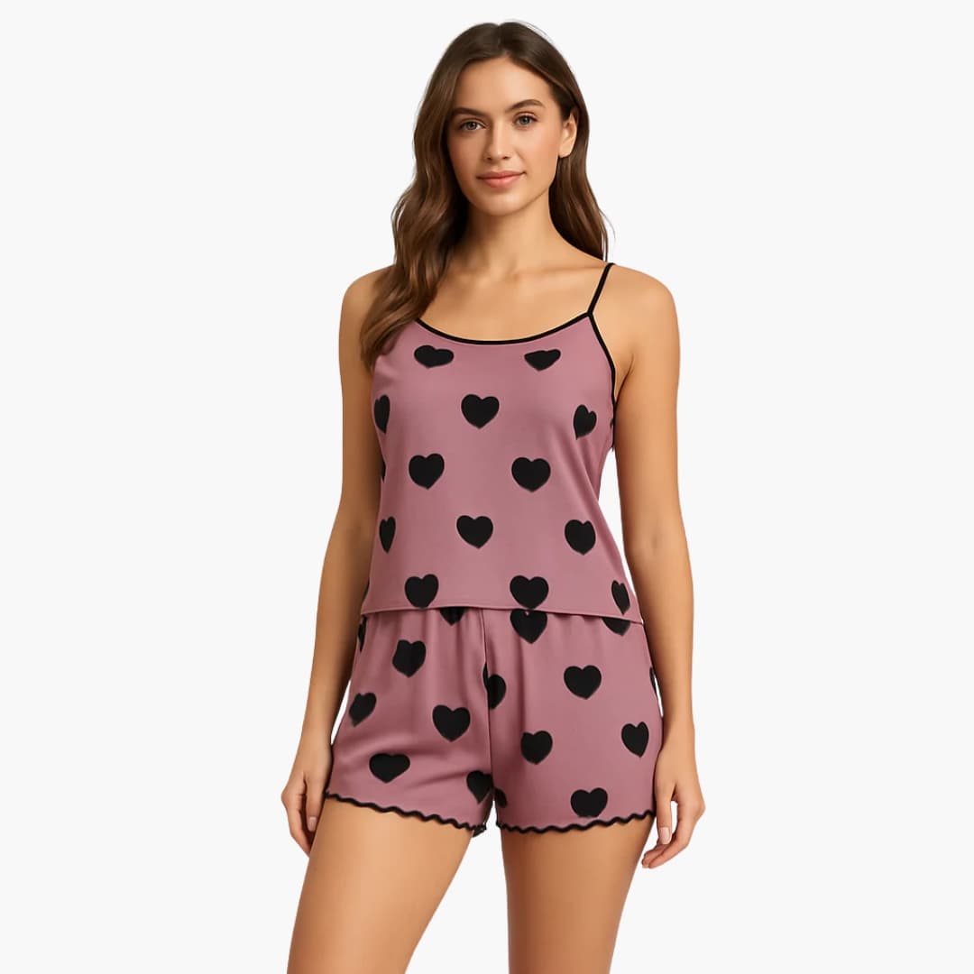 Women's two-piece pink heart-print pajama set; cami-style top with thin straps and matching shorts.