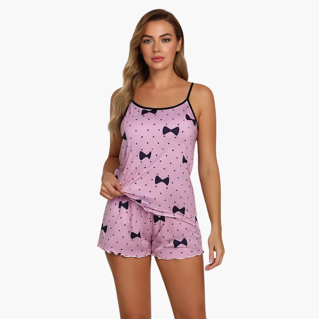 Women's pink two-piece pajama set with bow-print camisole and shorts, polka-dot pattern.