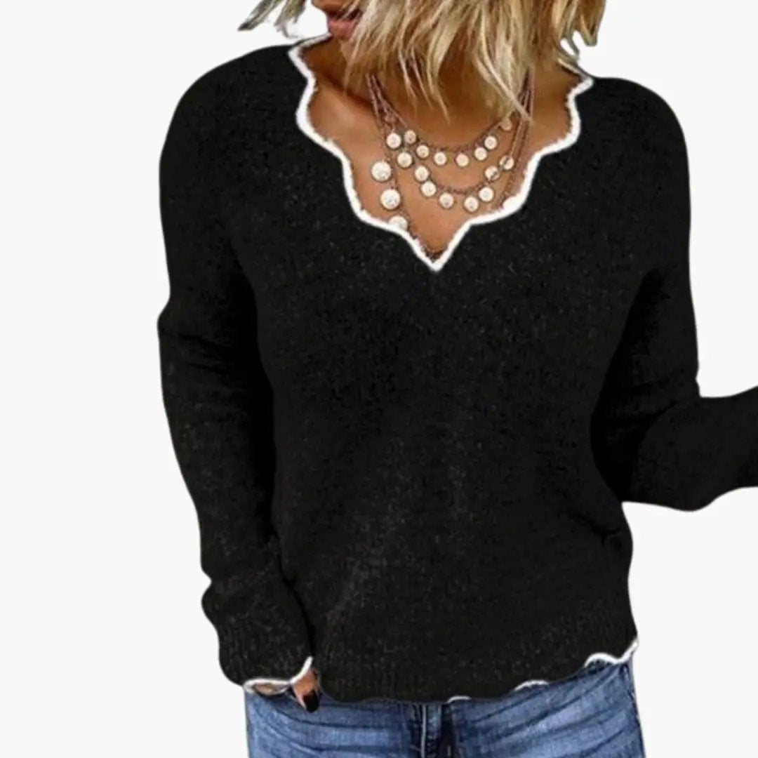 Women's black knit sweater with white wavy-edge neckline