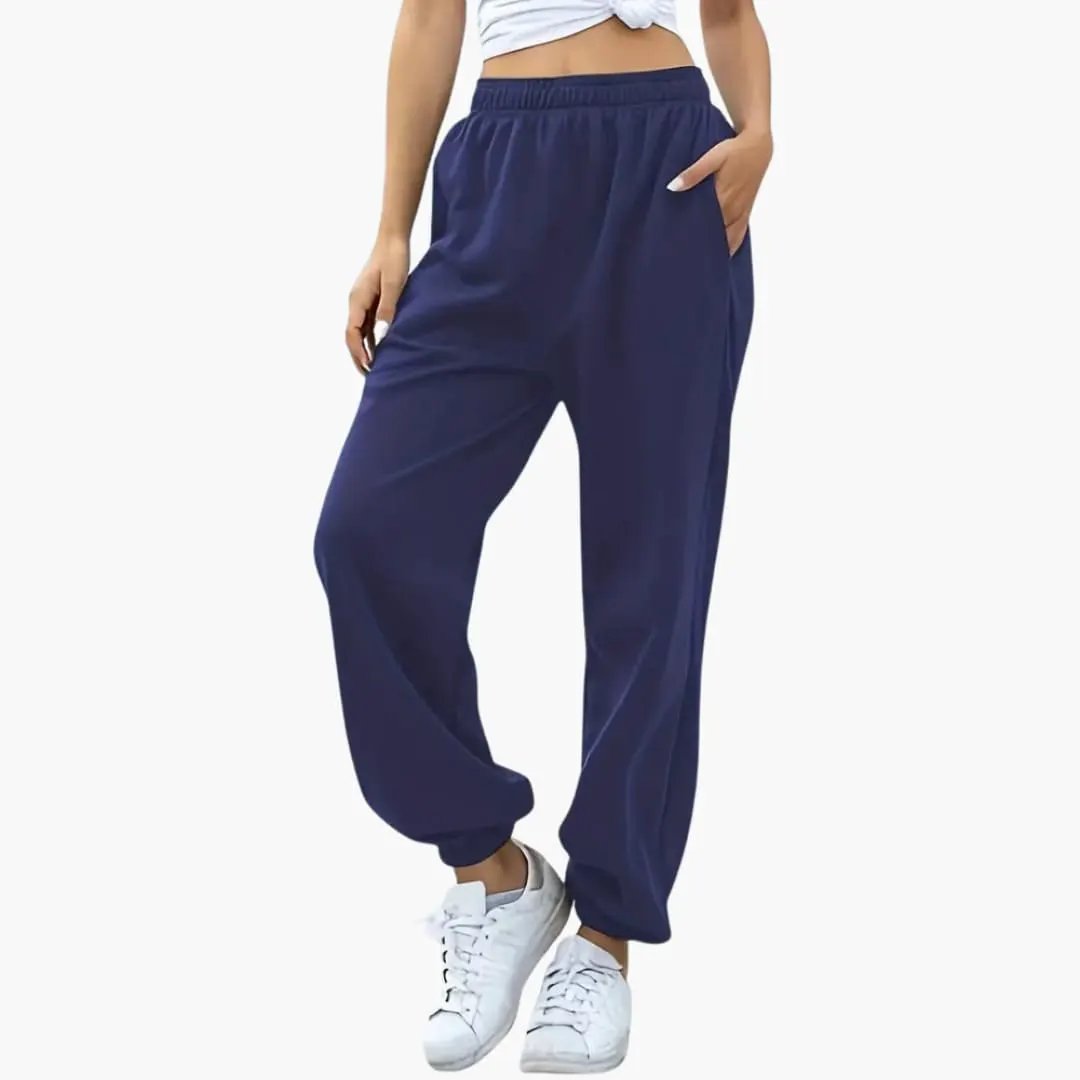 Women's navy baggy sweatpants with side pockets and elastic cuffs.