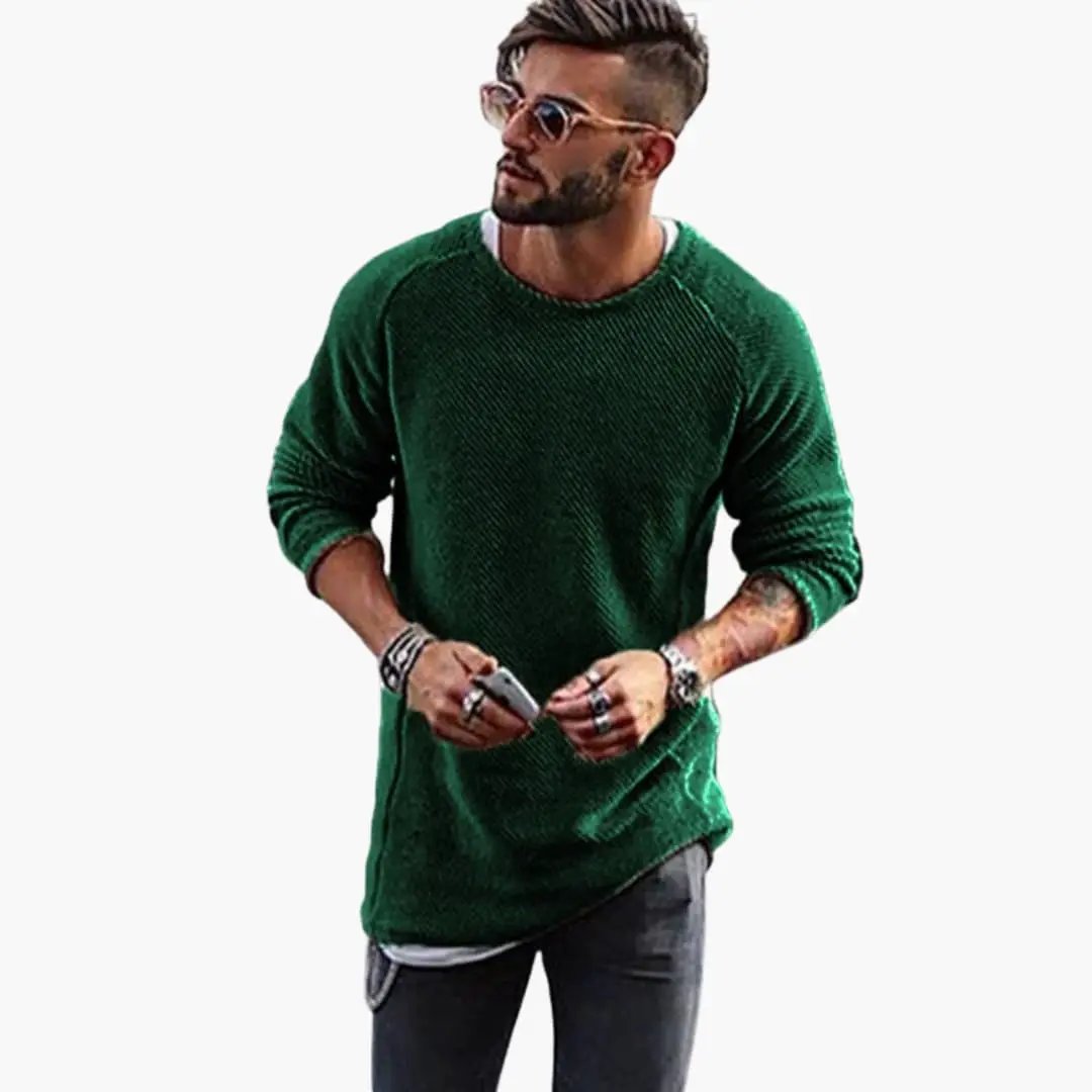 Men's knitted green sweater with round neck and ribbed cuffs, shown on a stylish male model