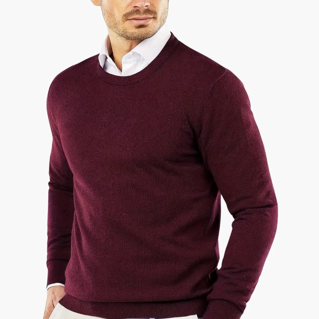 Men's burgundy knitted sweater with long sleeves worn over a white shirt