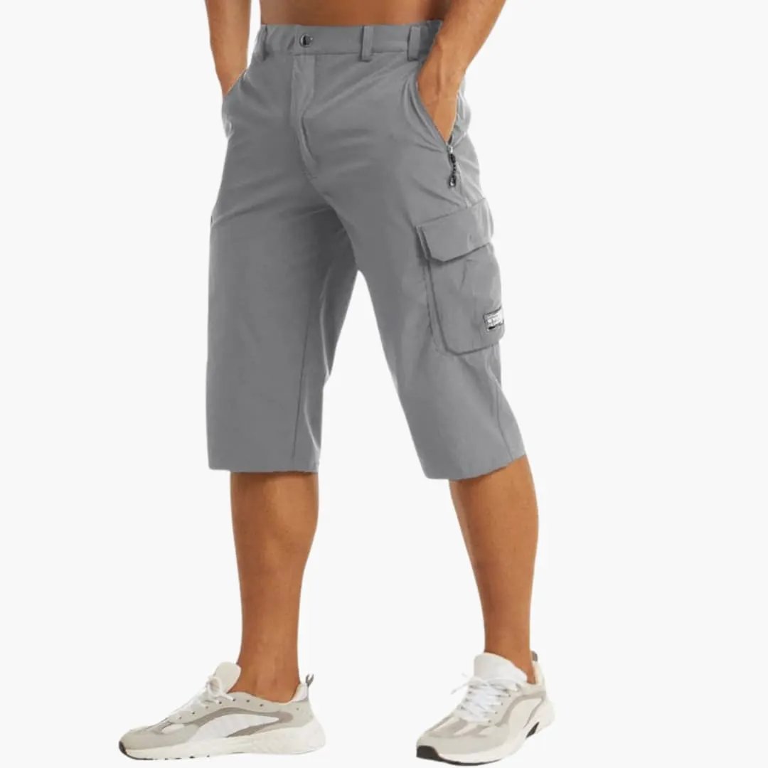 Men's cargo shorts in gray stretch fabric with knee-length, zippered pockets.