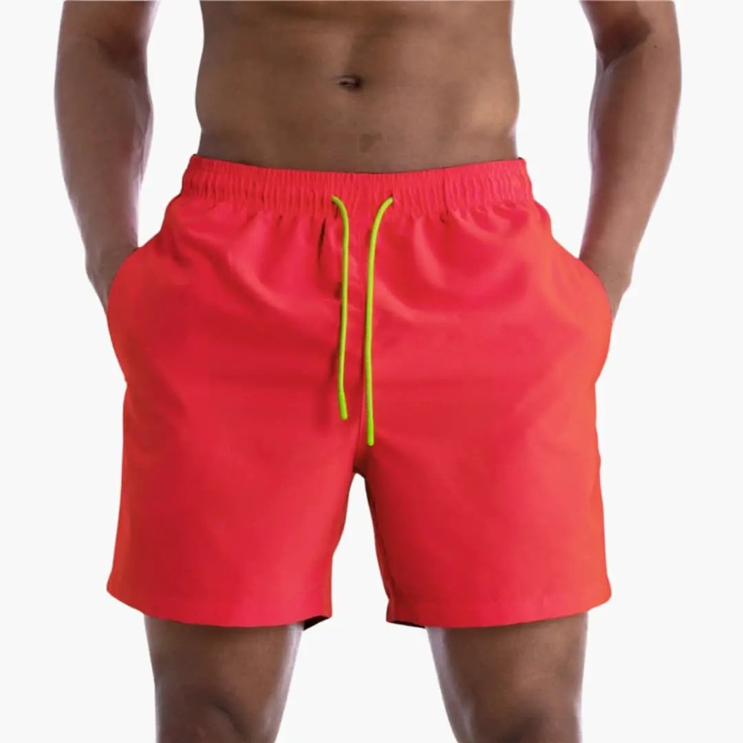 Men's jogger shorts in bright red with neon green drawstring and elastic waistband