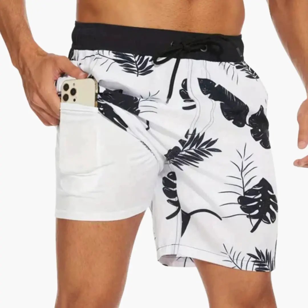Men’s boardshorts with palm leaf print, white base and black waistband, drawstring waist, side pocket