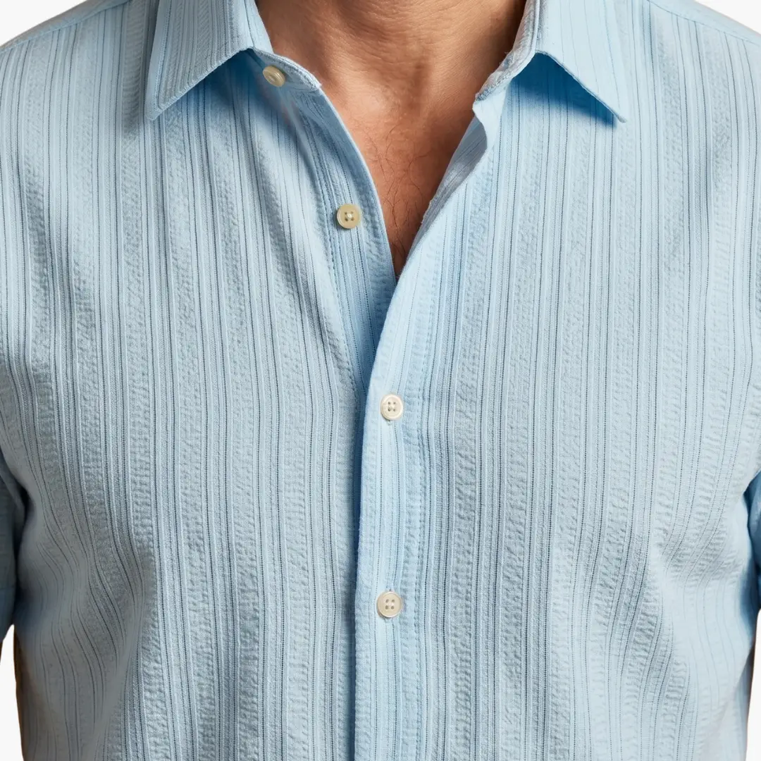 Men's striped button-up shirt in light blue with textured vertical stripes by Wilfred Smith