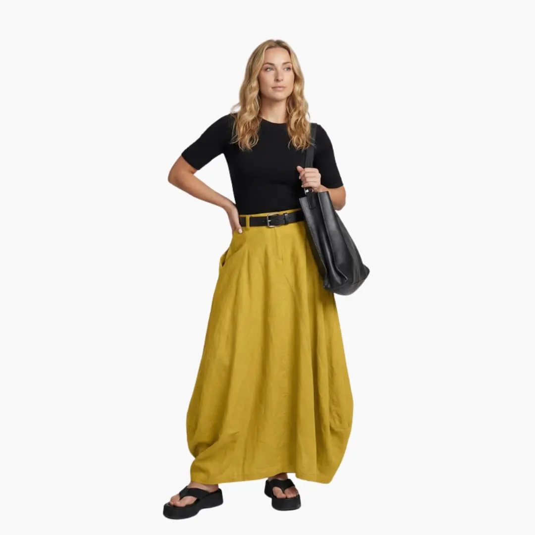 Women's mustard yellow A-Line skirt with decorative seams and elastic waistband.