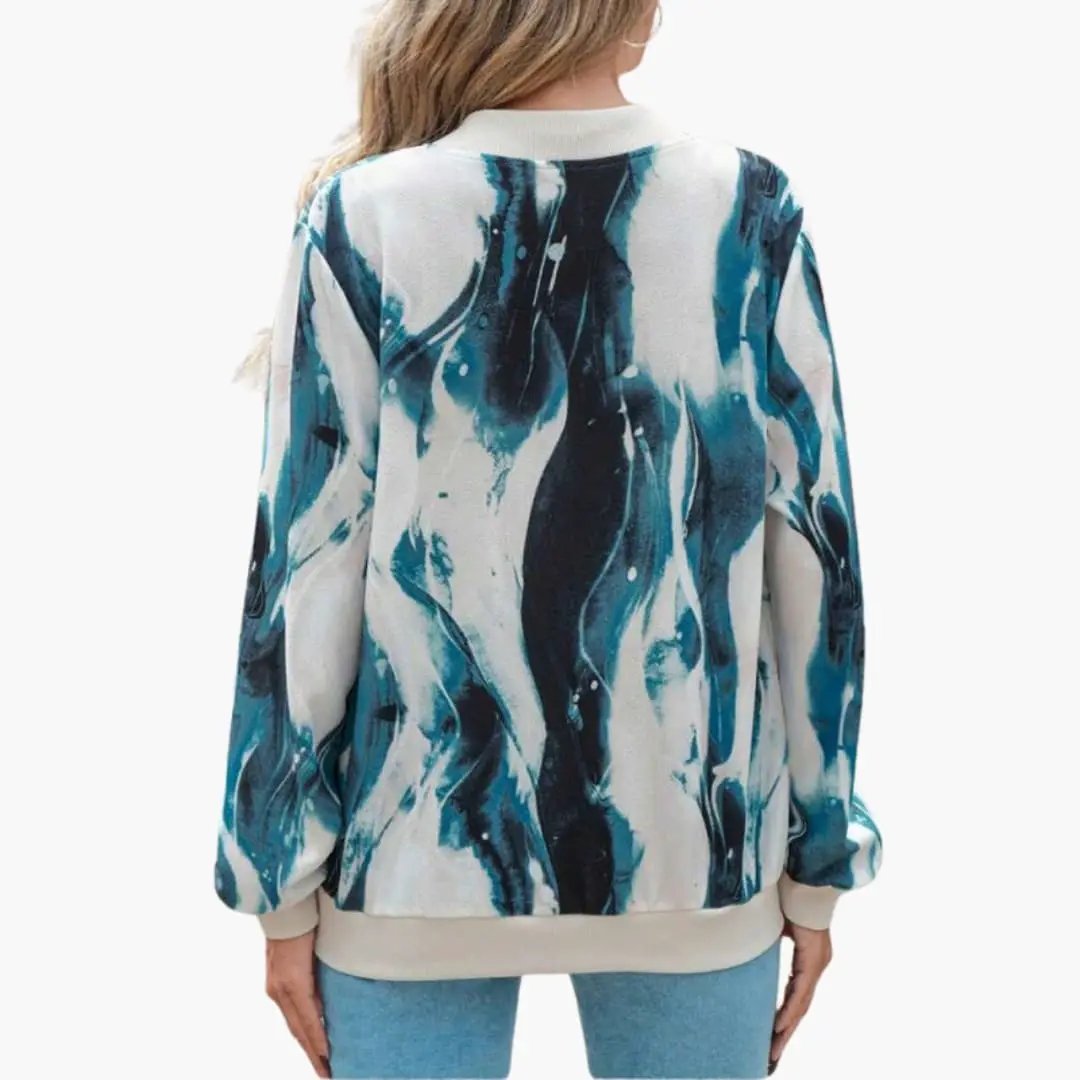 Wilfred Smith women's bomber jacket with abstract teal and navy print, front zip, beige ribbed cuffs and hem