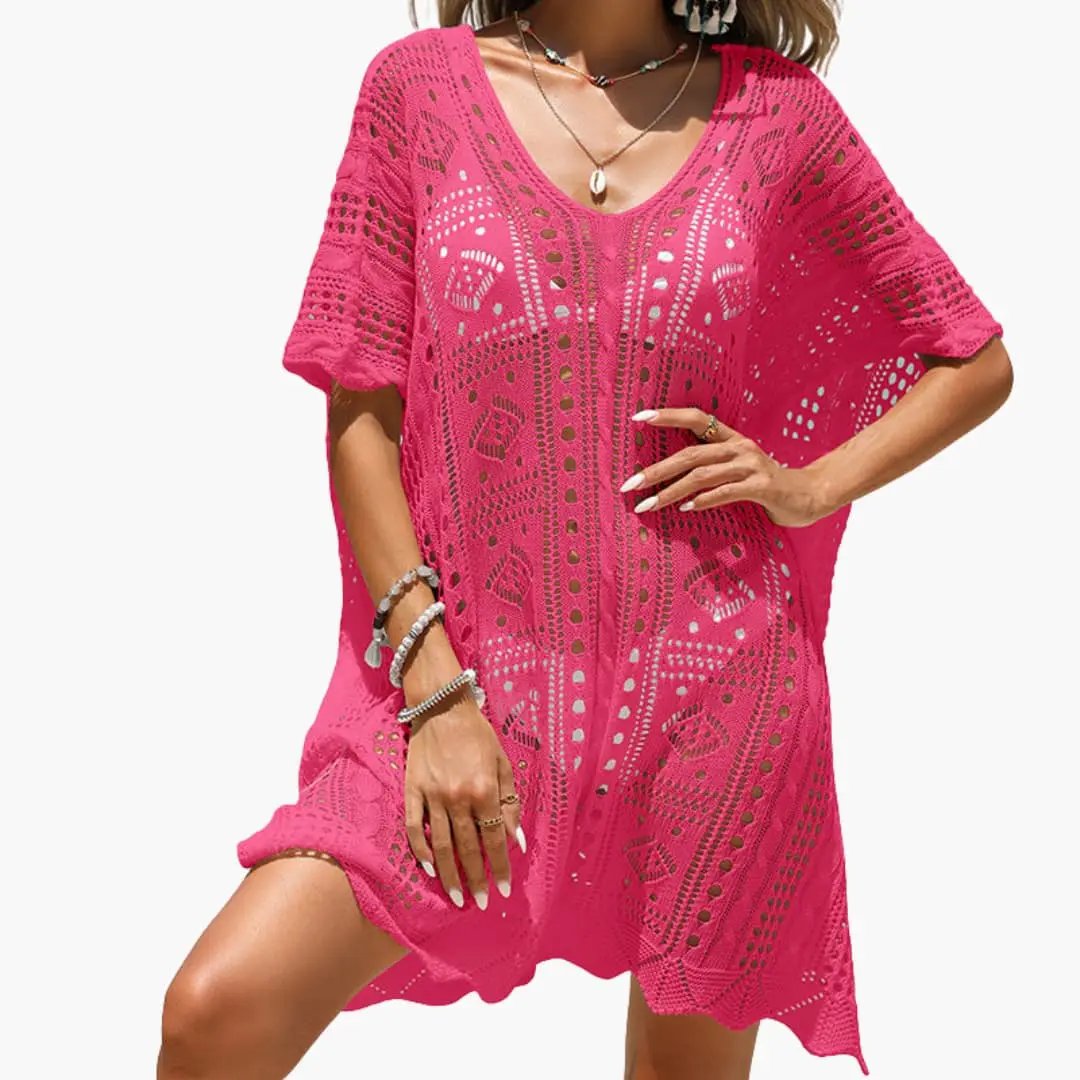 Women’s crochet beach dress by Wilfred Smith in bright pink with a V-neck and short sleeves.
