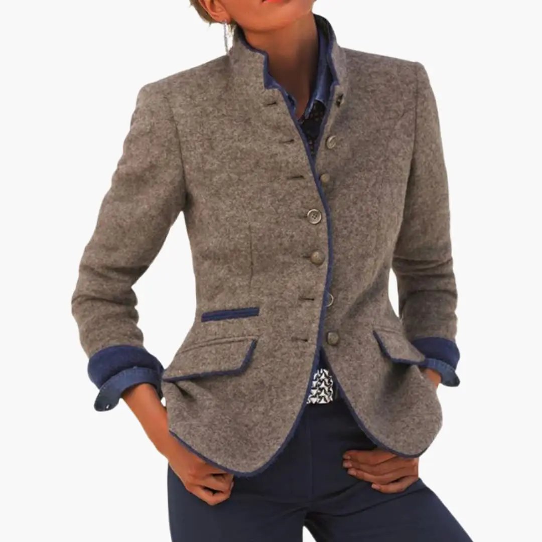 Women’s blazer with lapel collar in heather gray tweed, blue piping, button closure, and cuffed blue-trimmed sleeves.