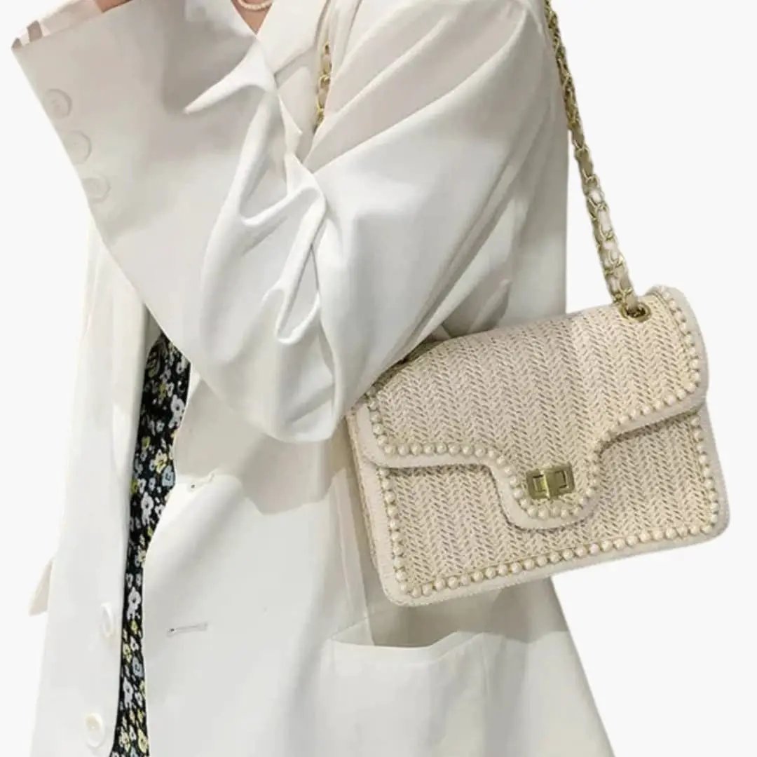 Women's handbag with gold-tone chain strap and pearl detailing in cream woven texture, shoulder bag