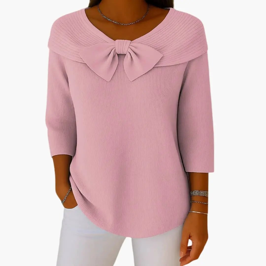 Pink women's knitted top with a bow neckline and 3/4 sleeves.