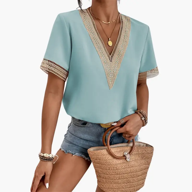 Women's lace-overlay blouse in light teal with beige lace-trim V-neck, hip-length top, and short sleeves.