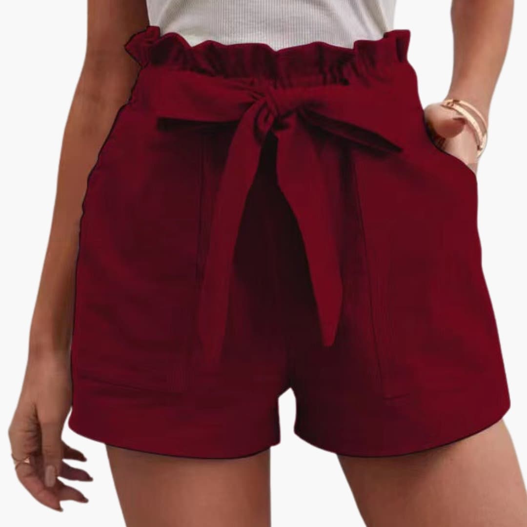 Women's burgundy linen shorts with a tied belt and wide waistband