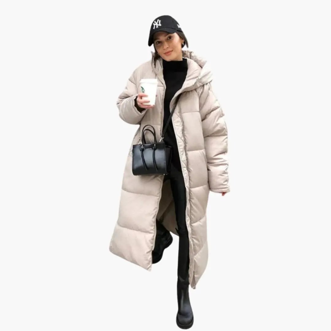 Women's long beige quilted hooded puffer jacket worn by model with black outfit and handbag