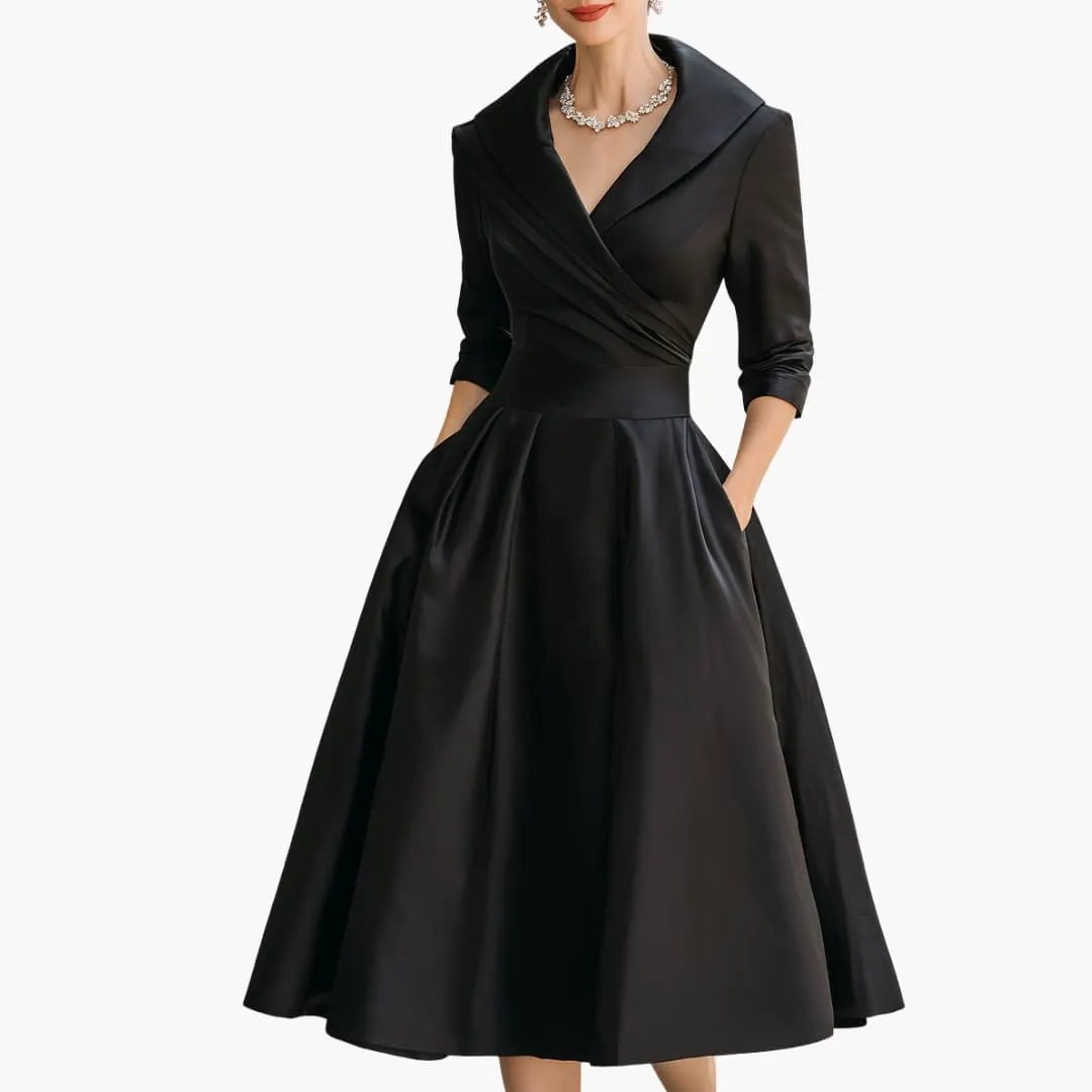 Women’s long sleeve midi dress in black satin with a wrapped bodice and fitted waist, mid-calf length