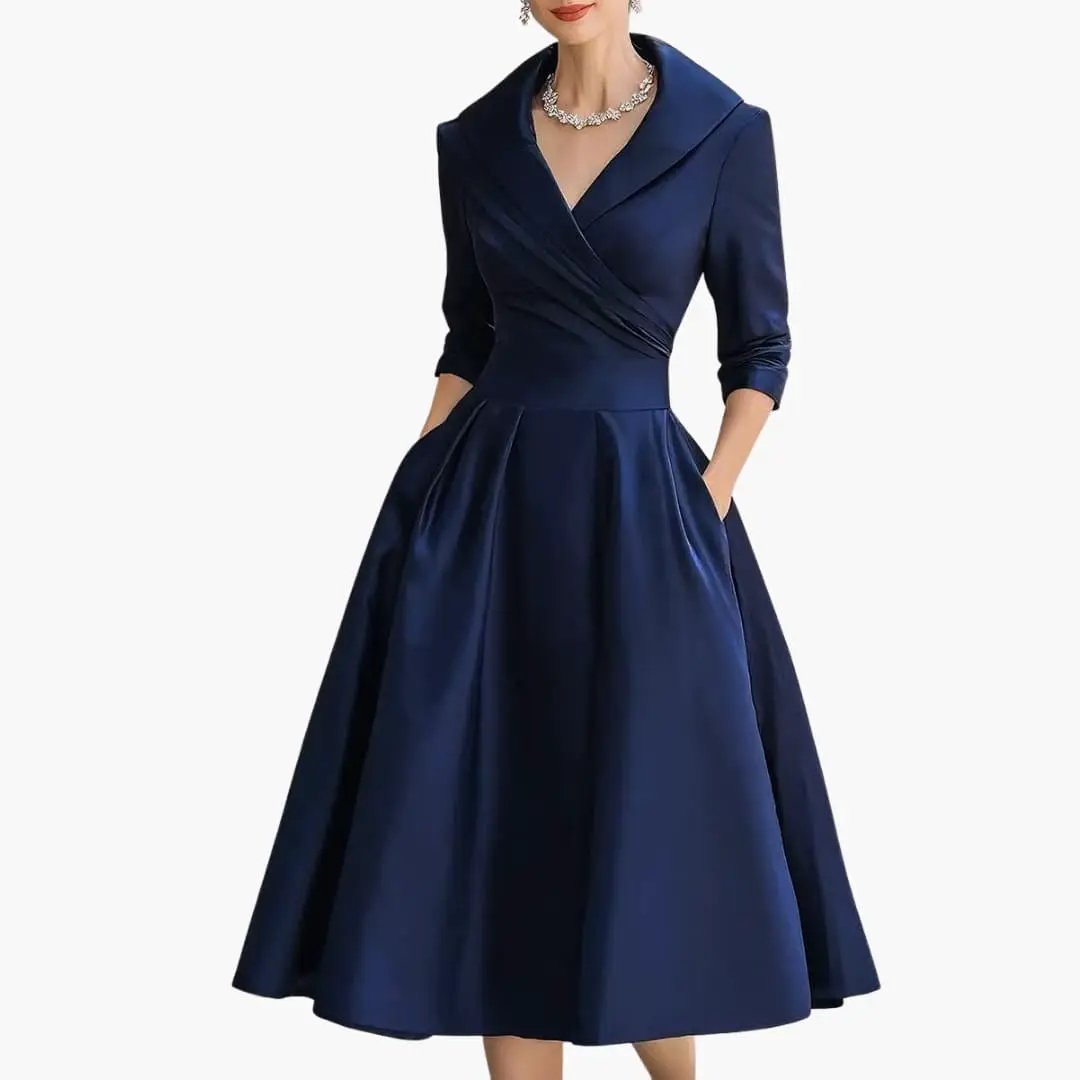 Women's long-sleeve midi dress by Wilfred Smith, navy satin with a fitted waist and pleated skirt.