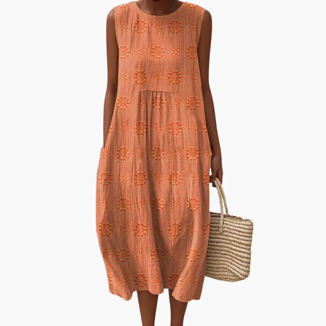 Wilfred Smith women's maxi dress, sleeveless with side pockets in peach fabric with orange floral embroidery