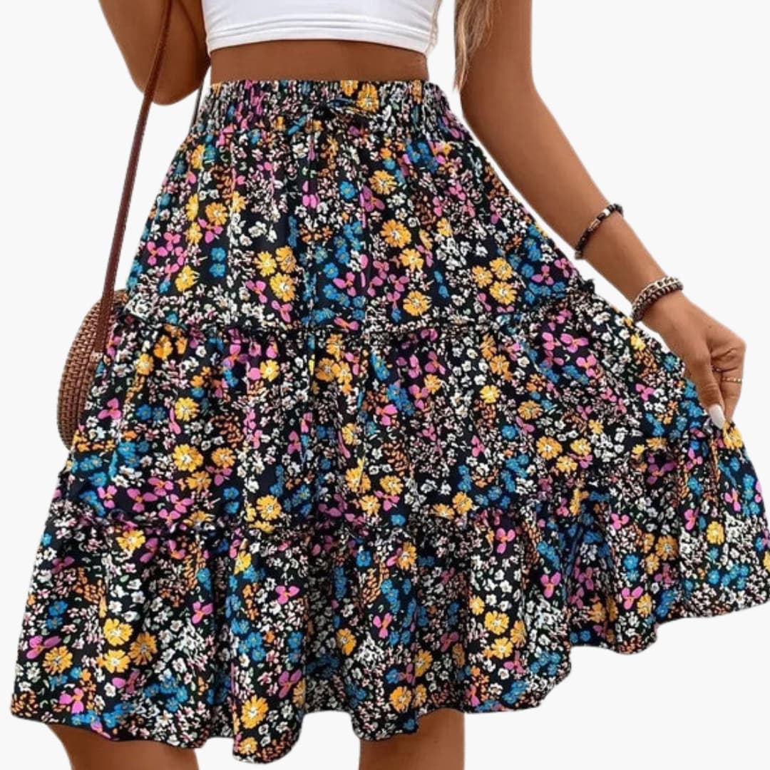 Women's floral midi skirt with elastic waistband and ruffled hem; black background with multicolor flowers.