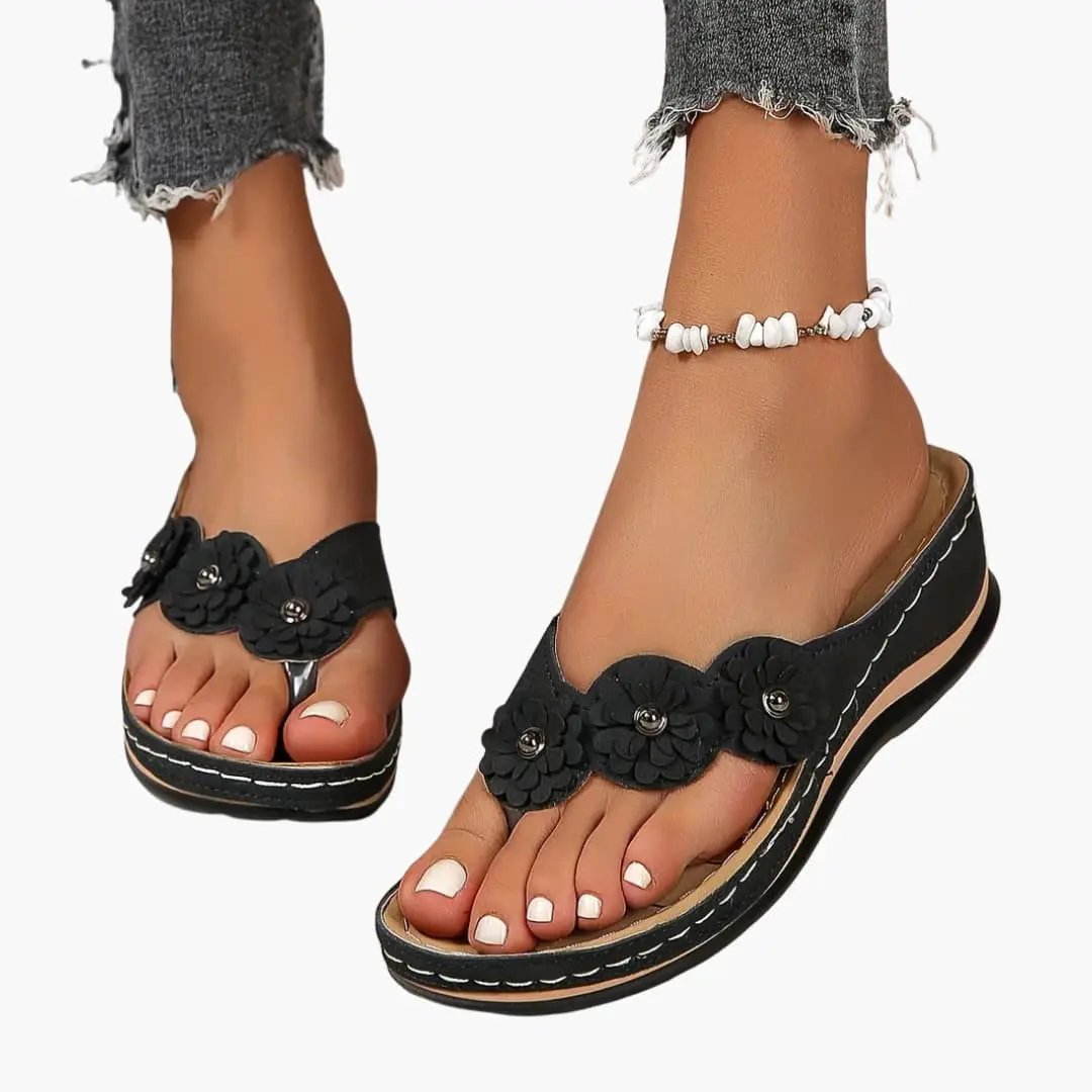 Women's black orthopedic sandals with slip-on fit, cushioned insole and floral-embellished strap