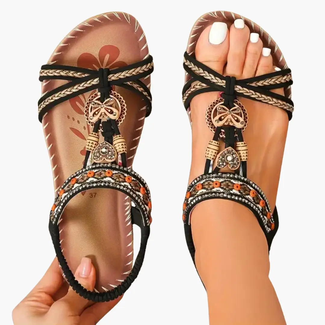 Pair of women's orthopedic sandals with black and beige braided straps and ornate beaded embellishments.