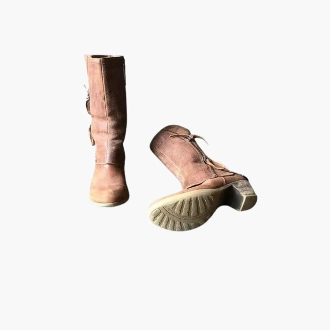 Pair of women's orthopedic boots with structured sole and pull tabs in brown suede