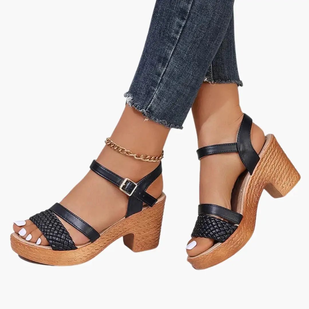 Women's platform sandals with woven upper and ankle strap by Wilfred Smith; black straps and cork-style platform.