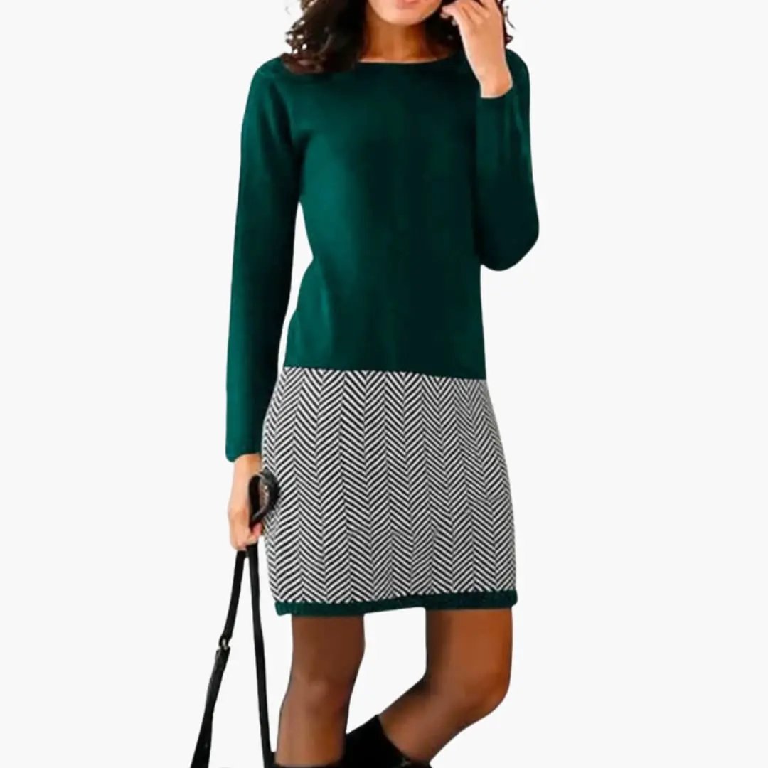 Women’s round neck dress in emerald green with a black-and-white houndstooth hem by Wilfred Smith.