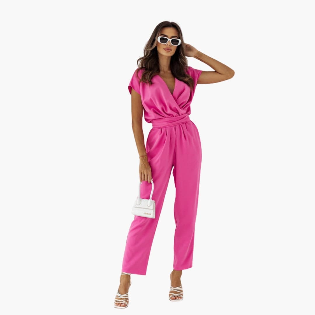 Women’s sleeveless V-neck jumpsuit with waist belt in bright pink, one-piece.