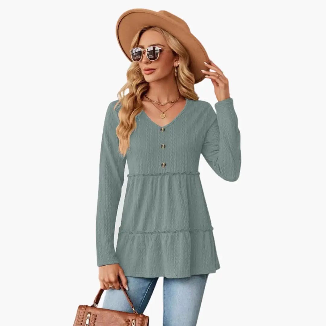 Women's teal V-neck tunic top with button accents, long sleeves, and flowing tiered hem.