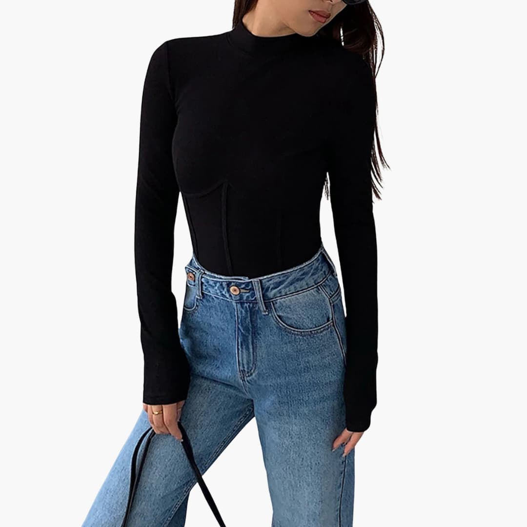 Women's slim-fit stand-collar piped T-shirt in black, worn by model with blue denim jeans for a casual chic look.