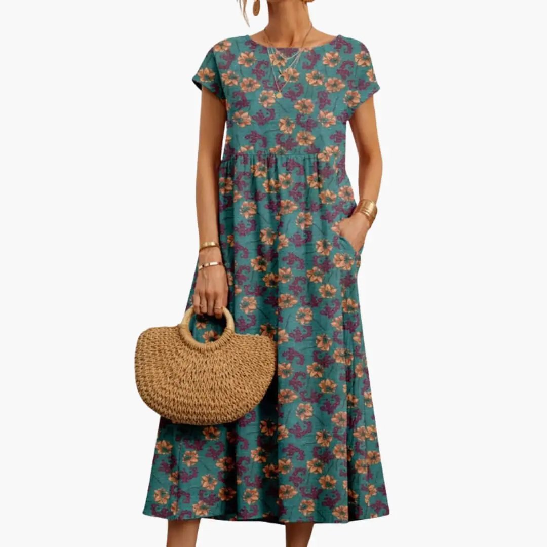 Women's straight-cut teal floral midi dress with short sleeves and round neck, pockets.