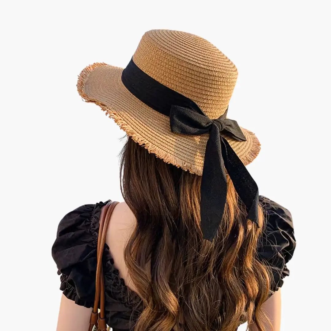 Women's sun hat with a wide straw brim and black ribbon bow.