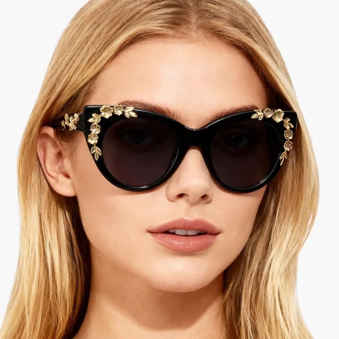 Women's cat-eye sunglasses by Wilfred Smith with black frame and gold floral accents, polycarbonate lenses, UV400.